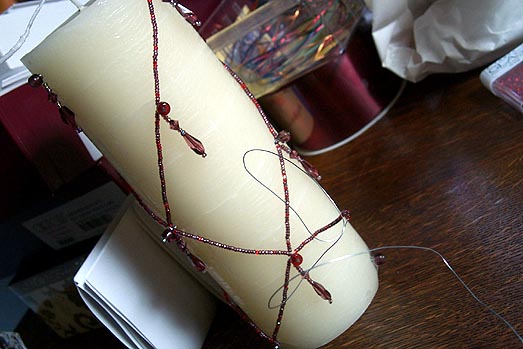 The candle, with about half of its string of seed beads in place.